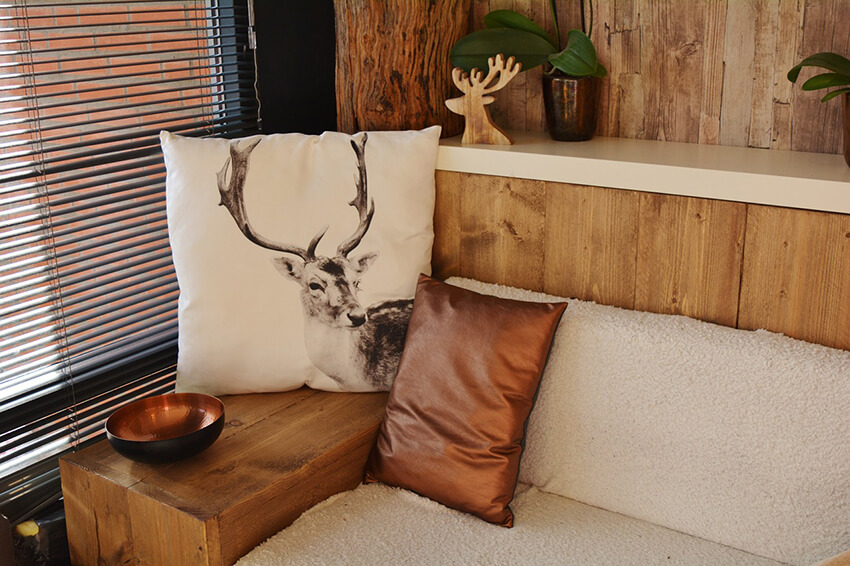 A wooden sofa with animal Print decorative cushions