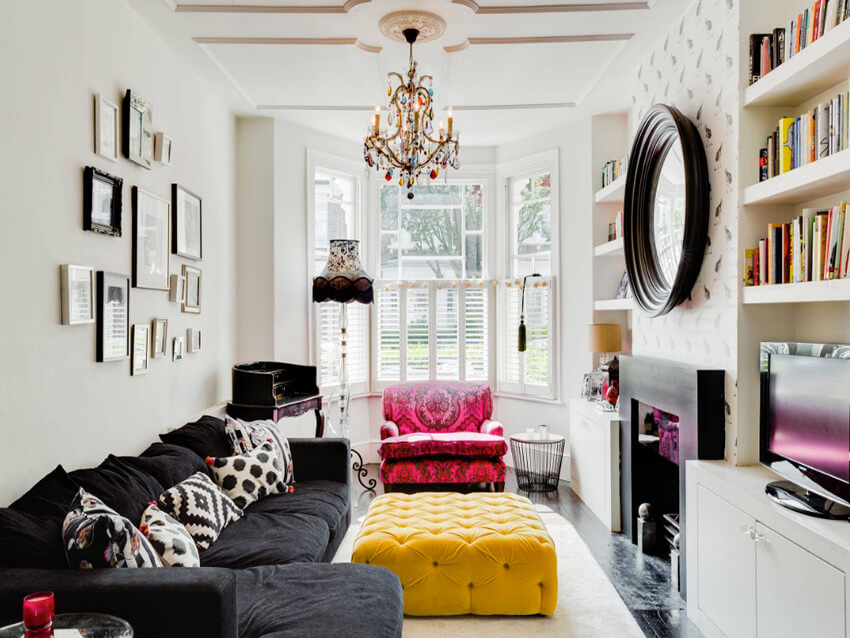 a contemporary art deco living room with bold colored furniture, and Black and white ultra-stylish cushions 