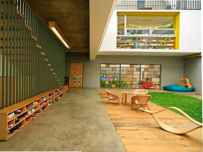 a modern kindergarten with green space and furniture