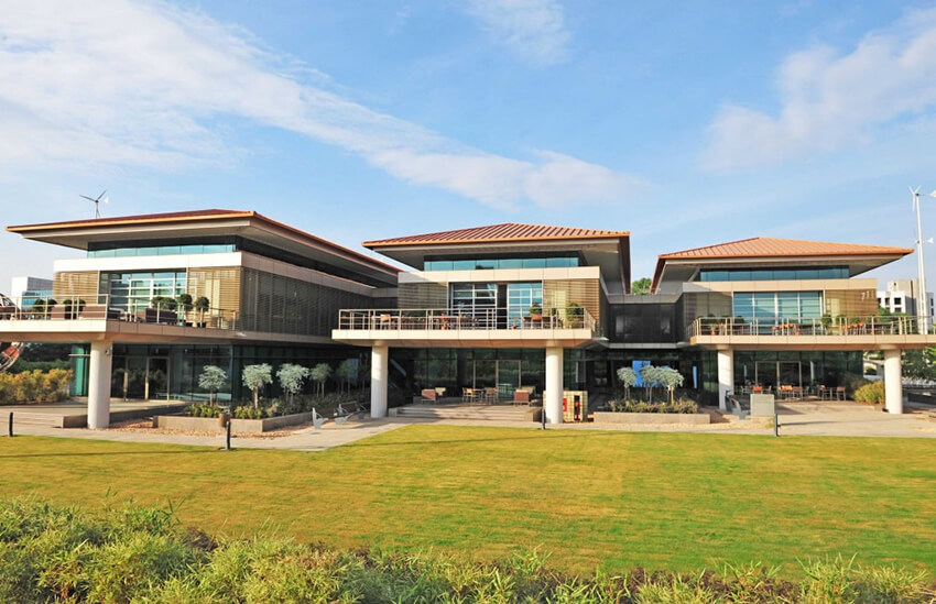 Suzlon One Earth, Pune, a building in green architecture style, surrounded by a green garden