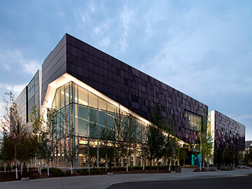 a modern facade design of a commercial building with glass and composite materials
