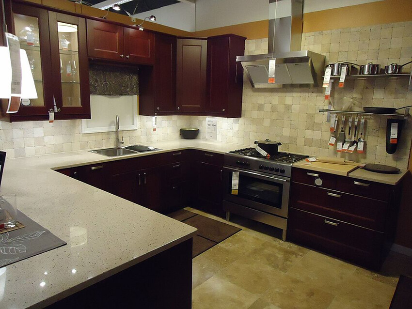 A semi-open kitchen being open from one side, brown cabinets