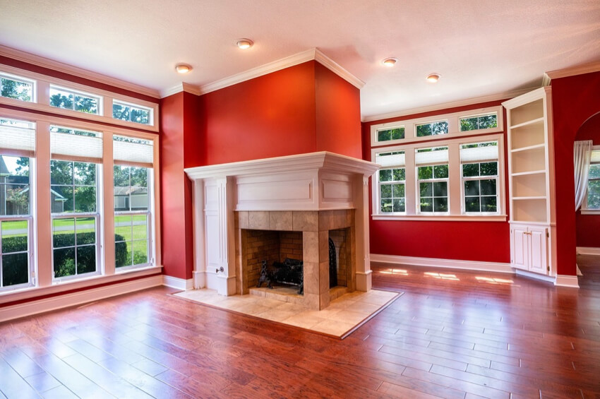 a warm-colored living room with fireplace and extensive glazing