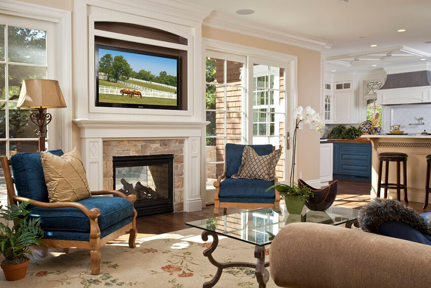 a bright living room with blue sofas and cream carpet