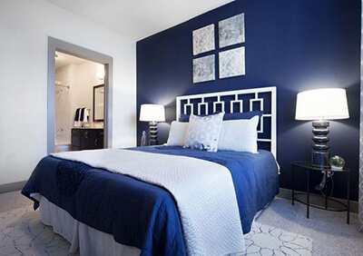 A bedroom with a blue wall