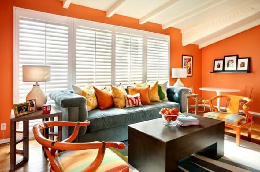 a living room with orange walls