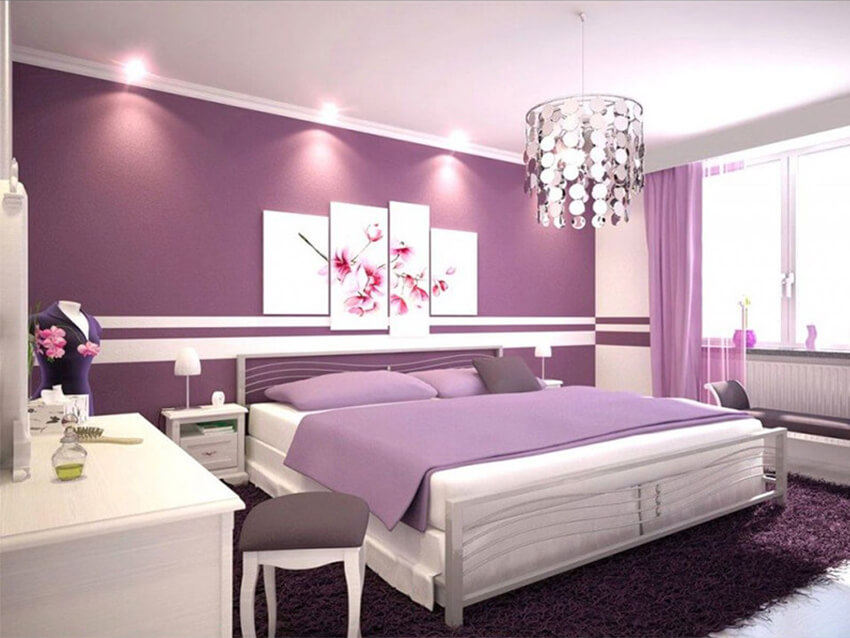A bedroom with purple wall paint