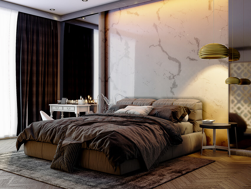 Modern master bedroom with wood flooring and natural stone wall behind the bed 