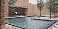 central courtyard of a modern brick house with water pool