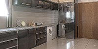 A kitchen design with stainless steel fridge, granite countertop, and two-toned kitchen cabinets