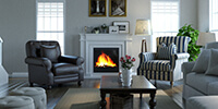 a living room with modern gas fireplace and armchairs in classic style