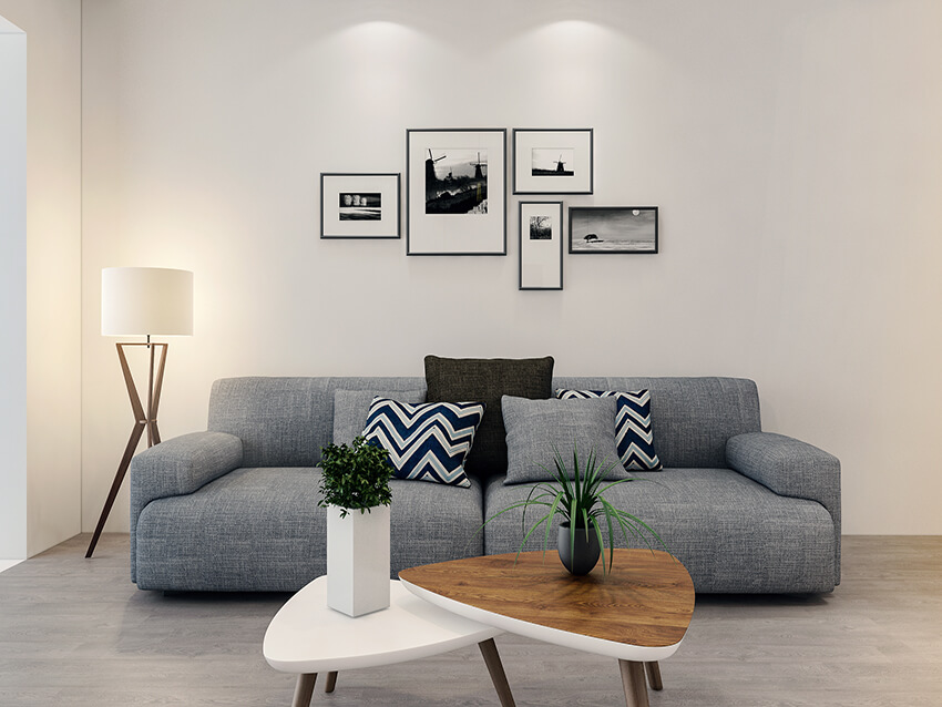 grey color modern sofa and two coffee tables in a modern living room with parquet flooring
