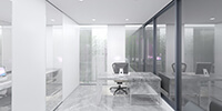 interior space of the office with glass partitions and bright stone flooring