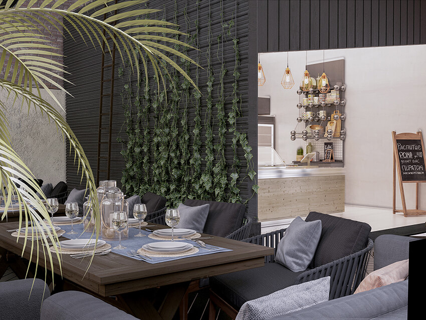 green wall in the interior space of a rustic restaurant with black walls and a wooden dining table