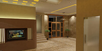 the entrance lobby of a modern office with cream color stone flooring and hidden ceiling lights